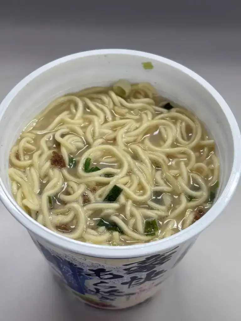 エースコック「まぐろのかぶとだし仕立て 濃厚魚介塩ラーメン」完成品。黄金色のスープに麺が絡む実食直前の様子。